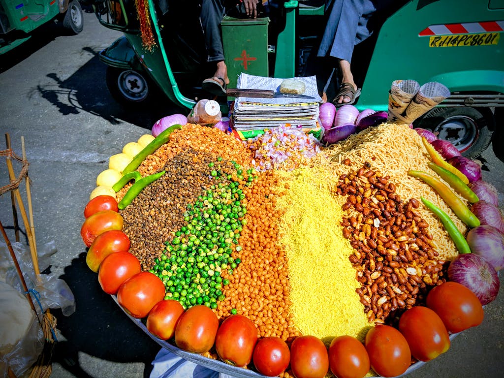 Vibrant street food display at a market in Jaipur showcasing traditional Indian snacks.
